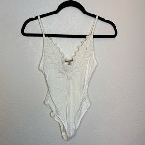 Free People bodysuit with lave and hardware detailing
